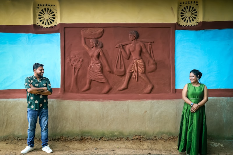 Couple standing together by wall