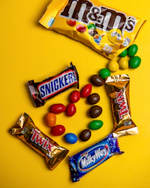 A variety of candy on a yellow background
