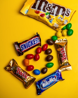 A variety of candy on a yellow background