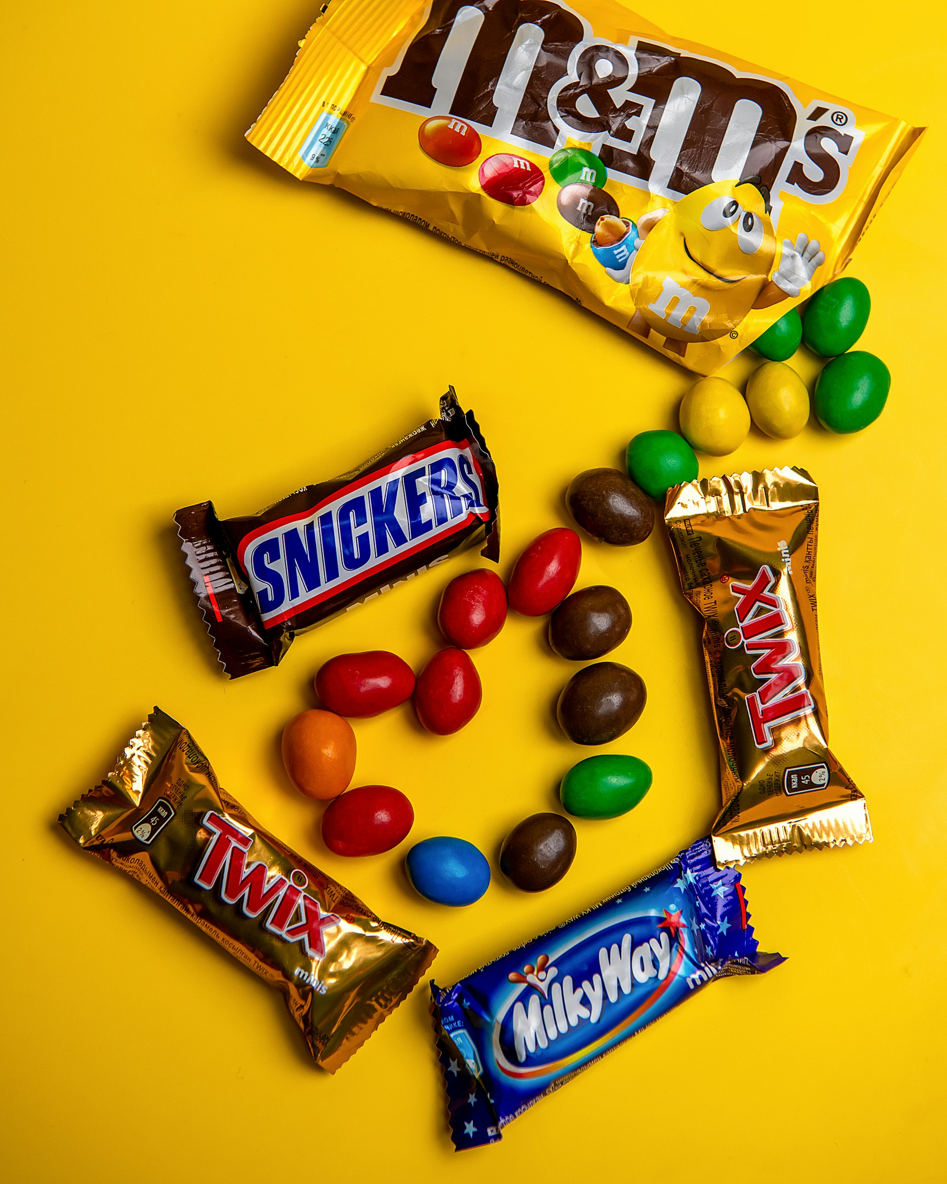 A variety of candy on a yellow background