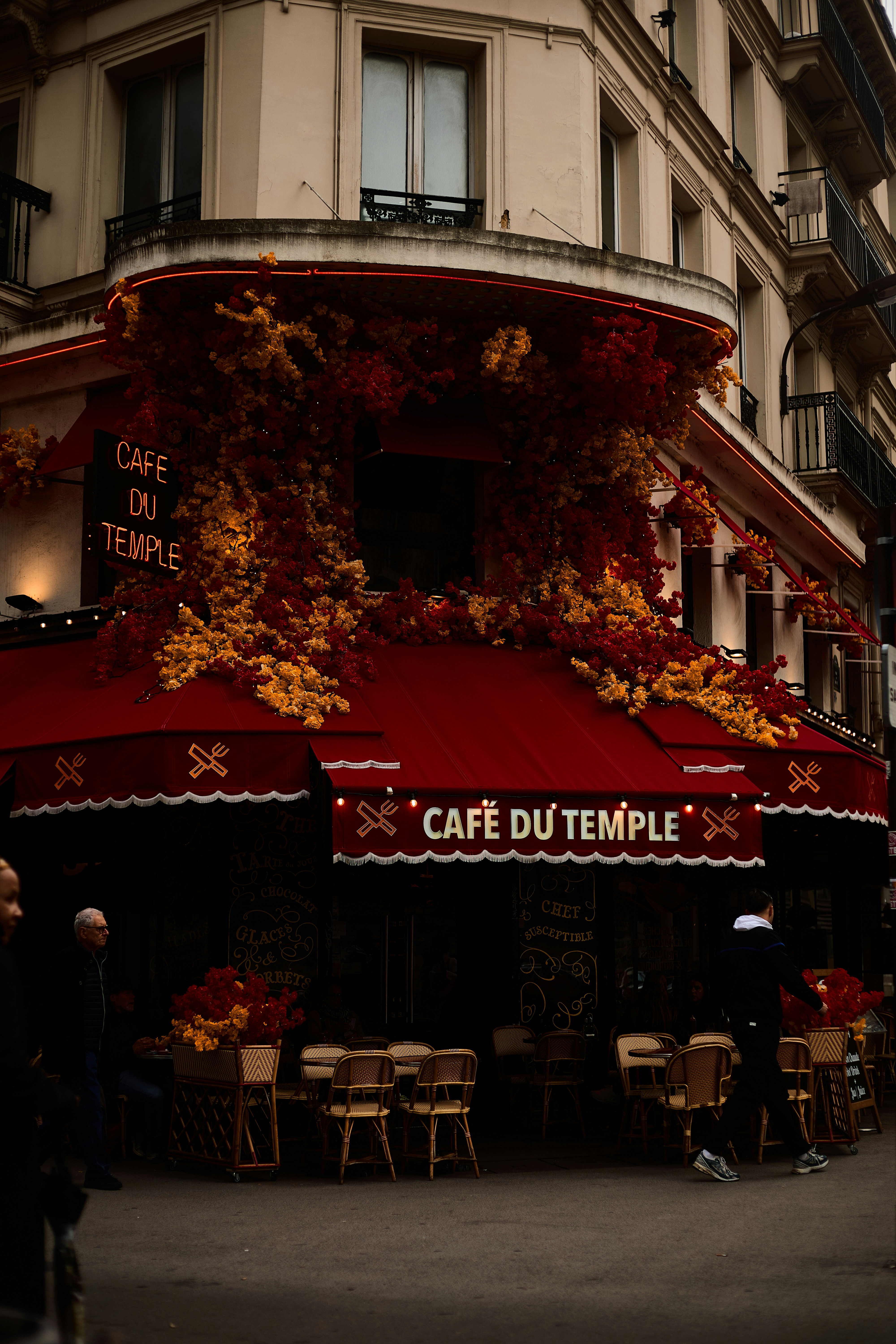 A cafe with a red awning on a city street