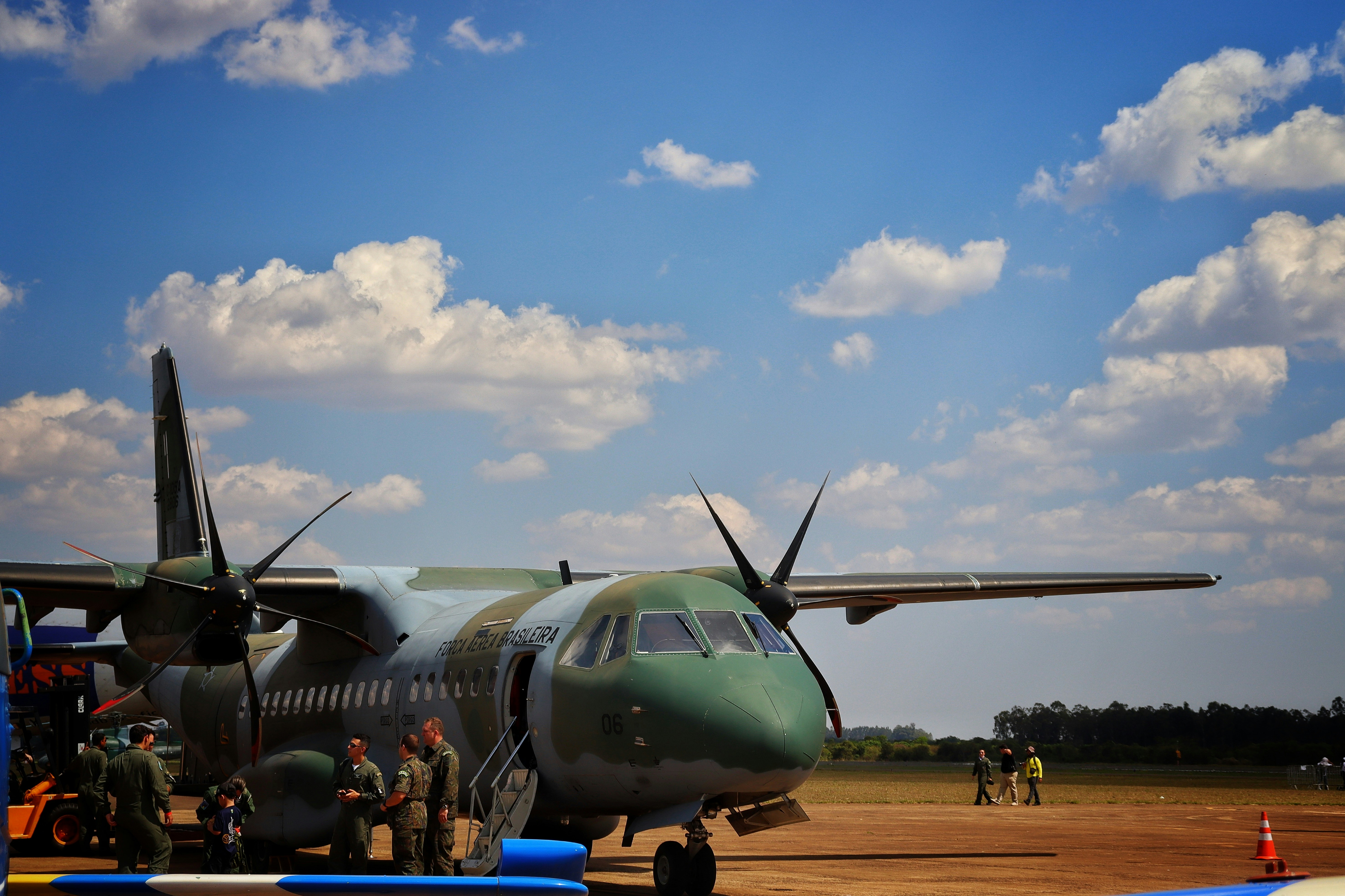 A large propeller plane sitting on top of an airport tarmac, 