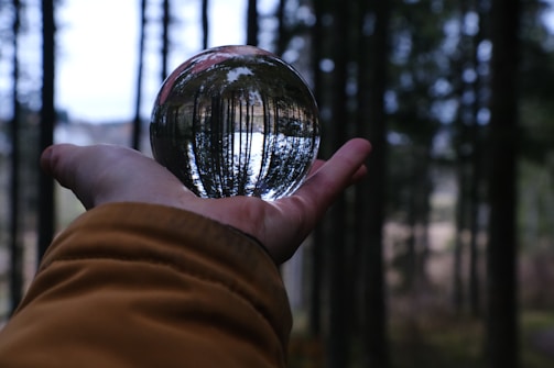 A person holding a crystal ball in their hand