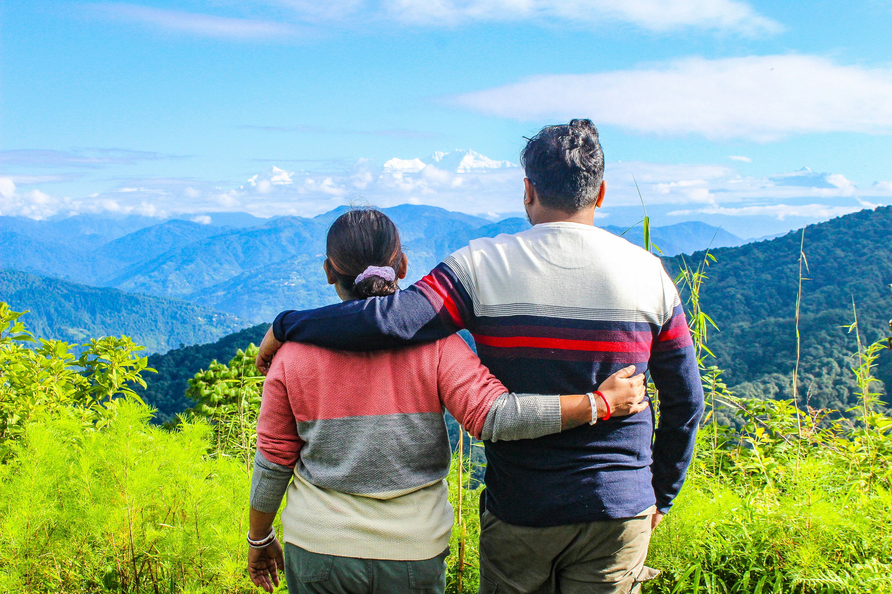 A couple of people that are standing in the grass