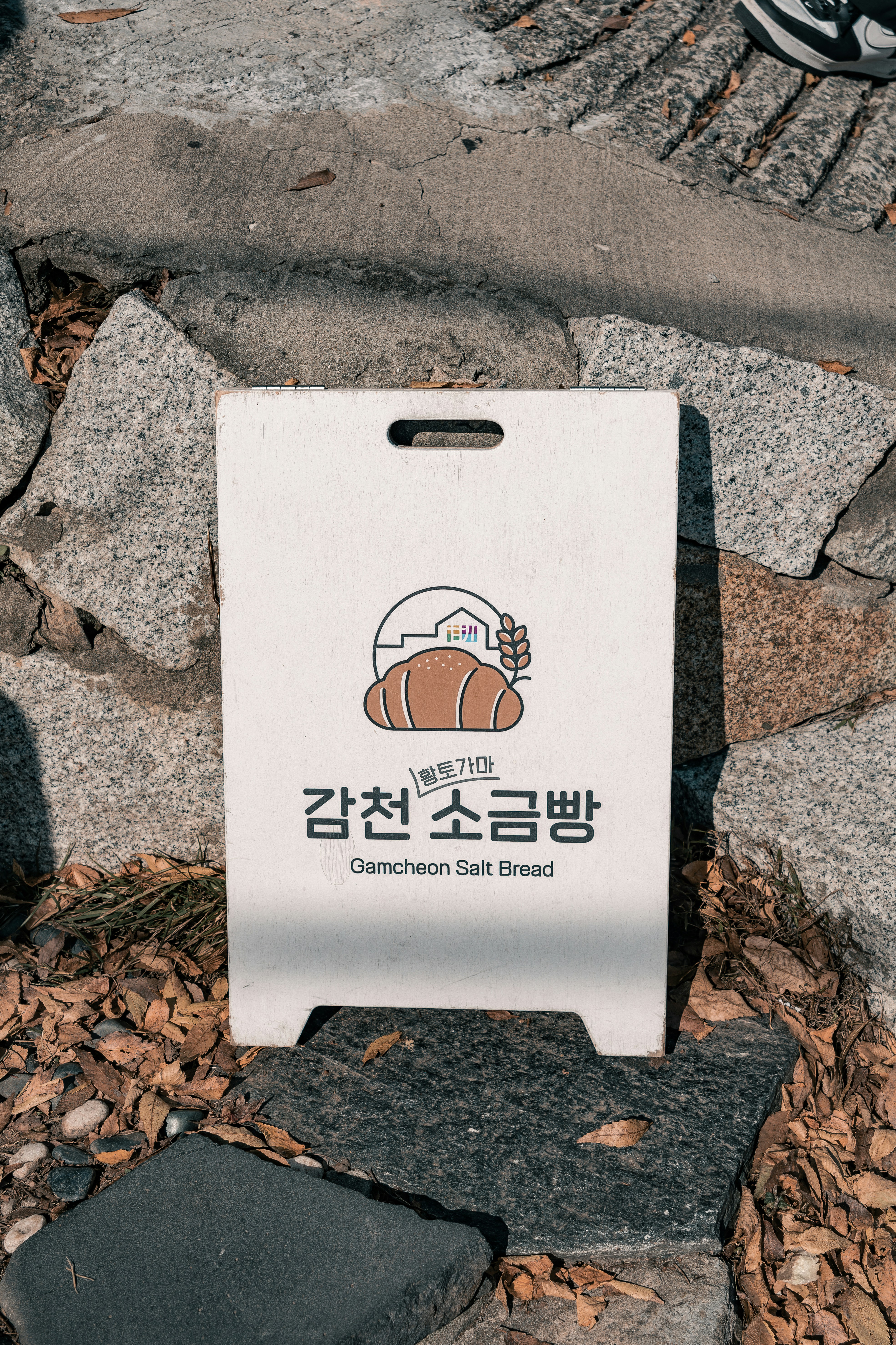 A white bag sitting on top of a pile of rocks