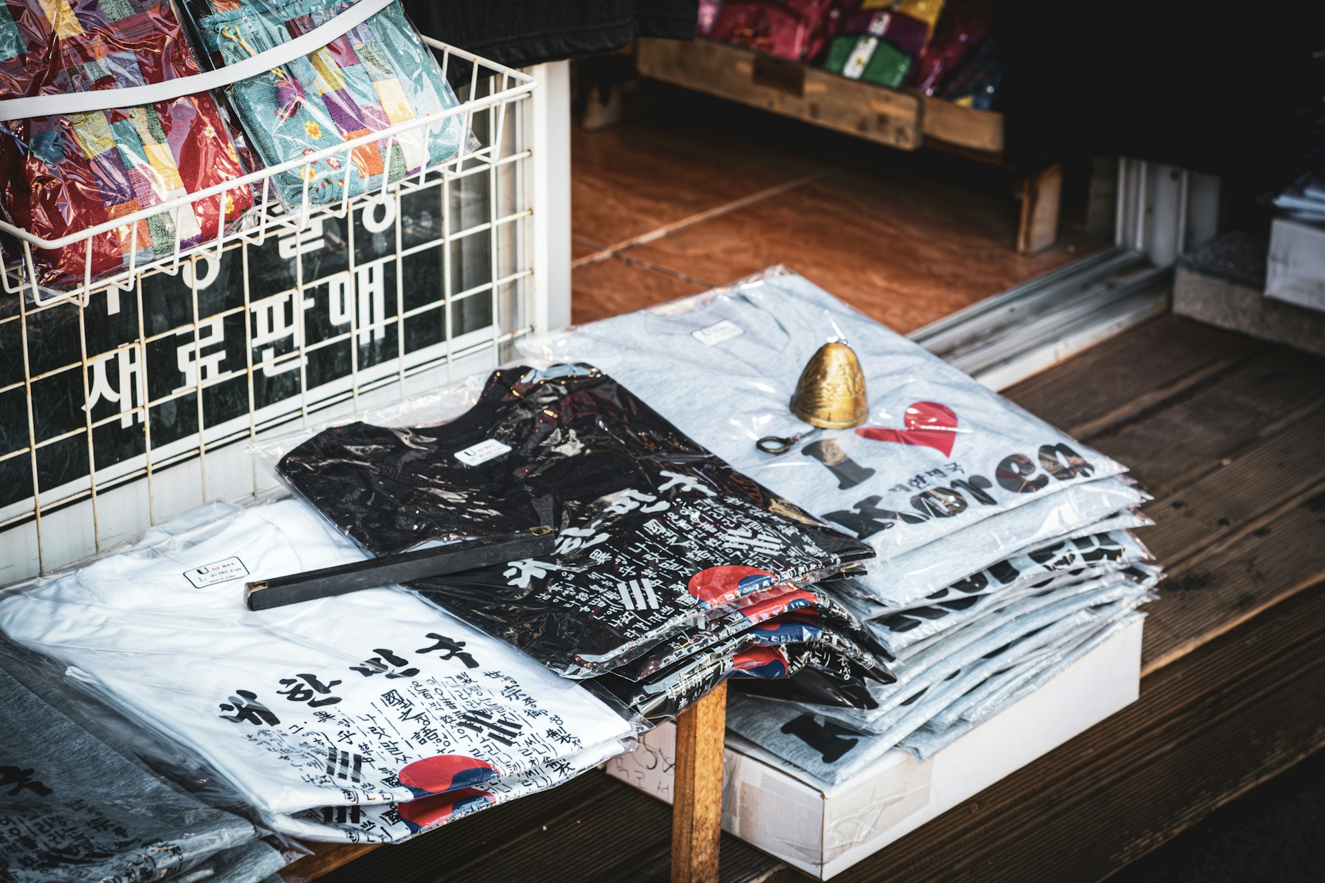 A pile of shirts sitting on top of a wooden floor
