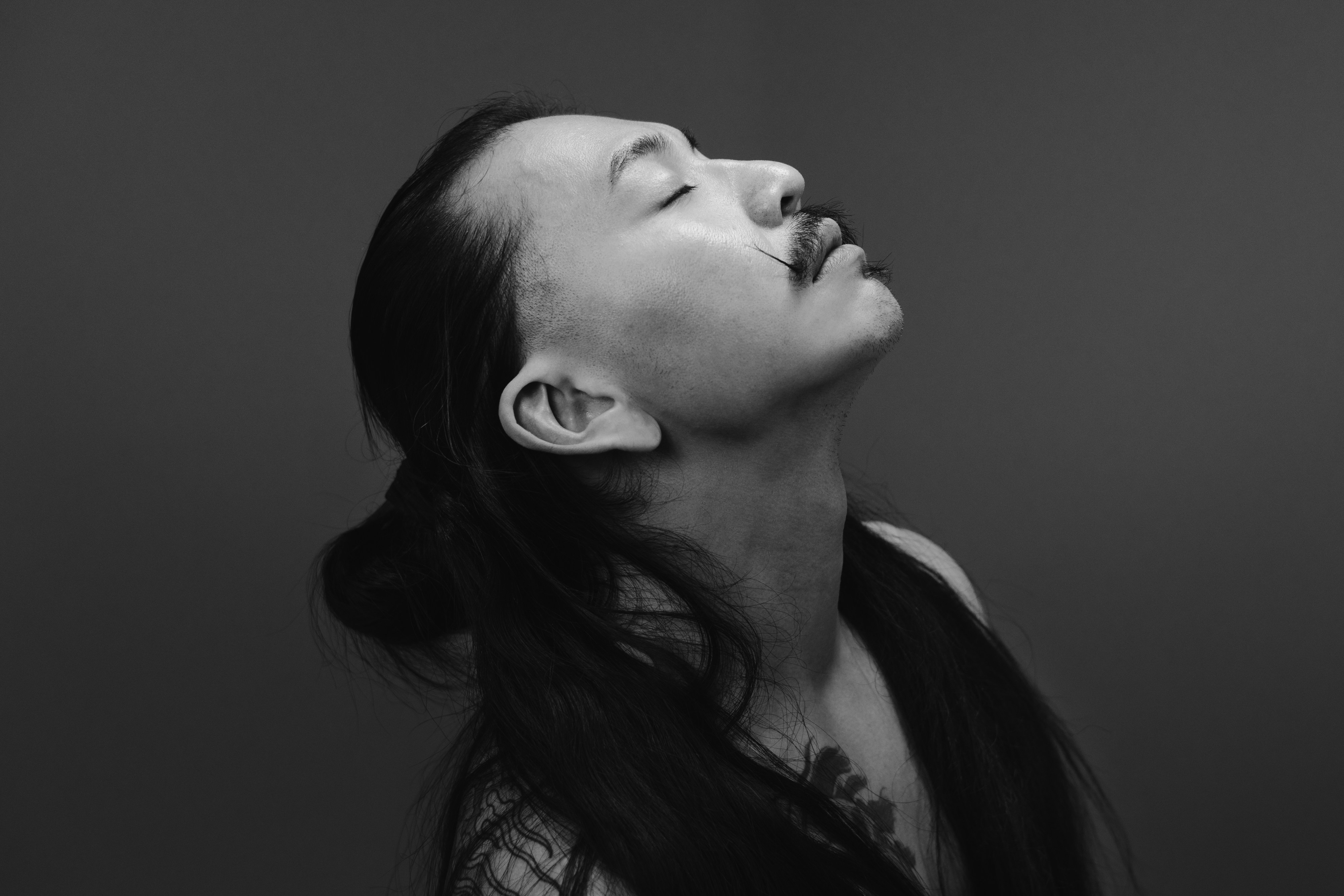 A black and white photo of a woman looking up
