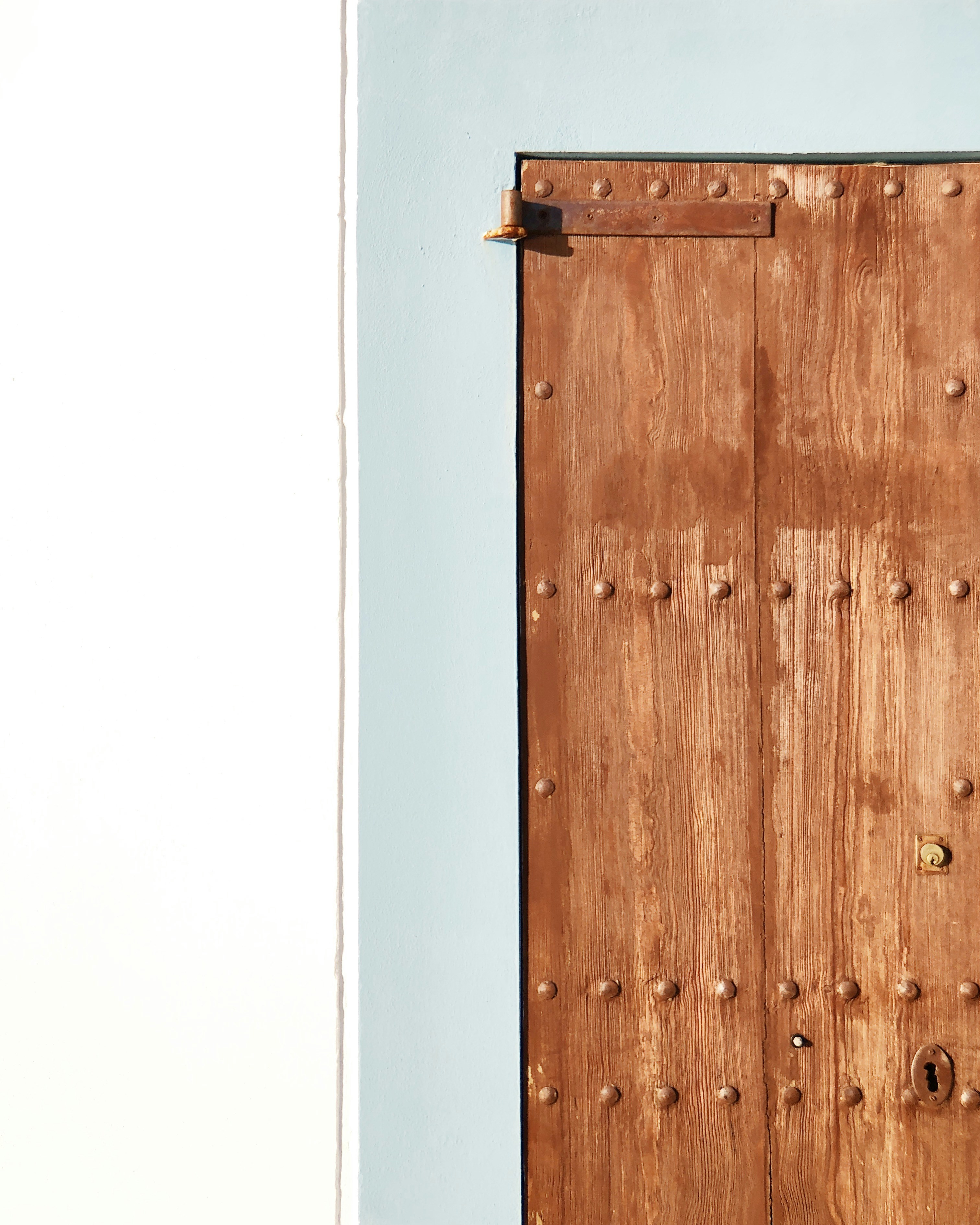 Vintage wooden door on a blue wall, Mediterranean House
