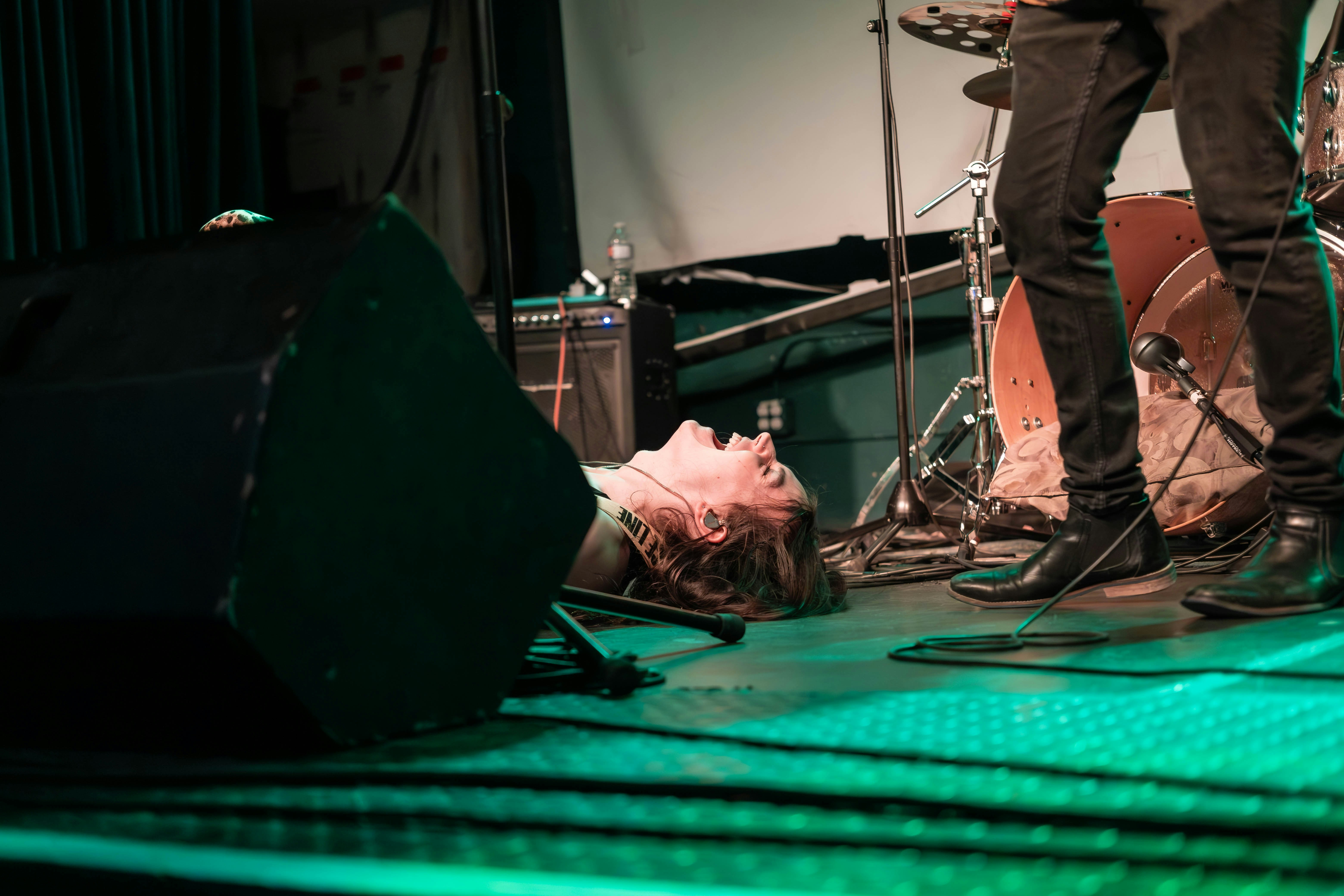 A man standing on top of a stage next to a microphone