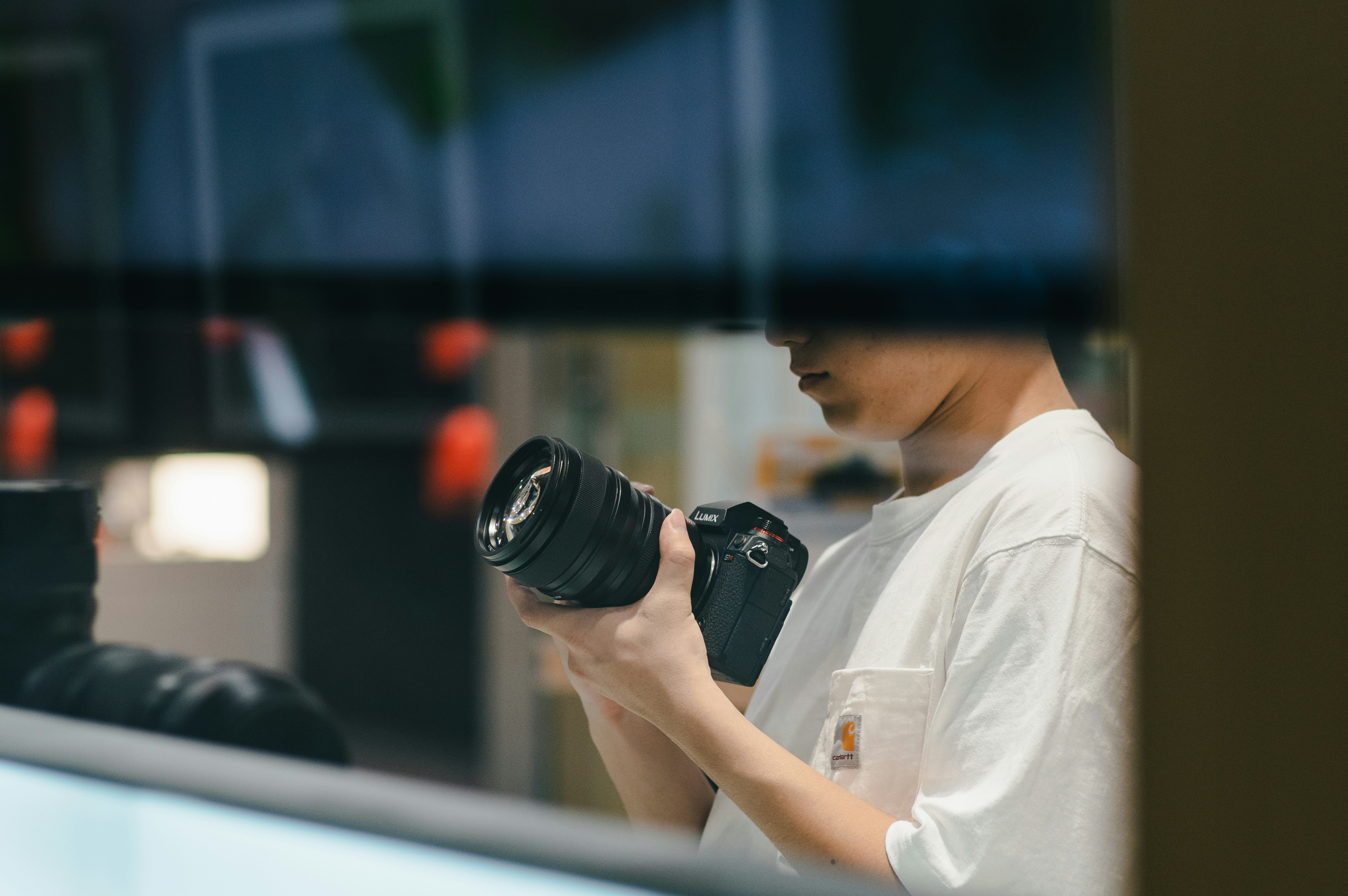 A man holding a camera in front of a mirror