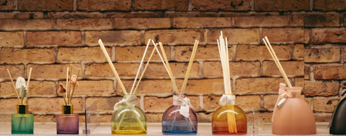 A row of bottles with sticks sticking out of them