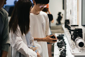 A man and a woman looking at cell phones