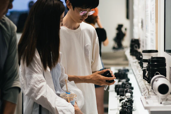 A man and a woman looking at cell phones