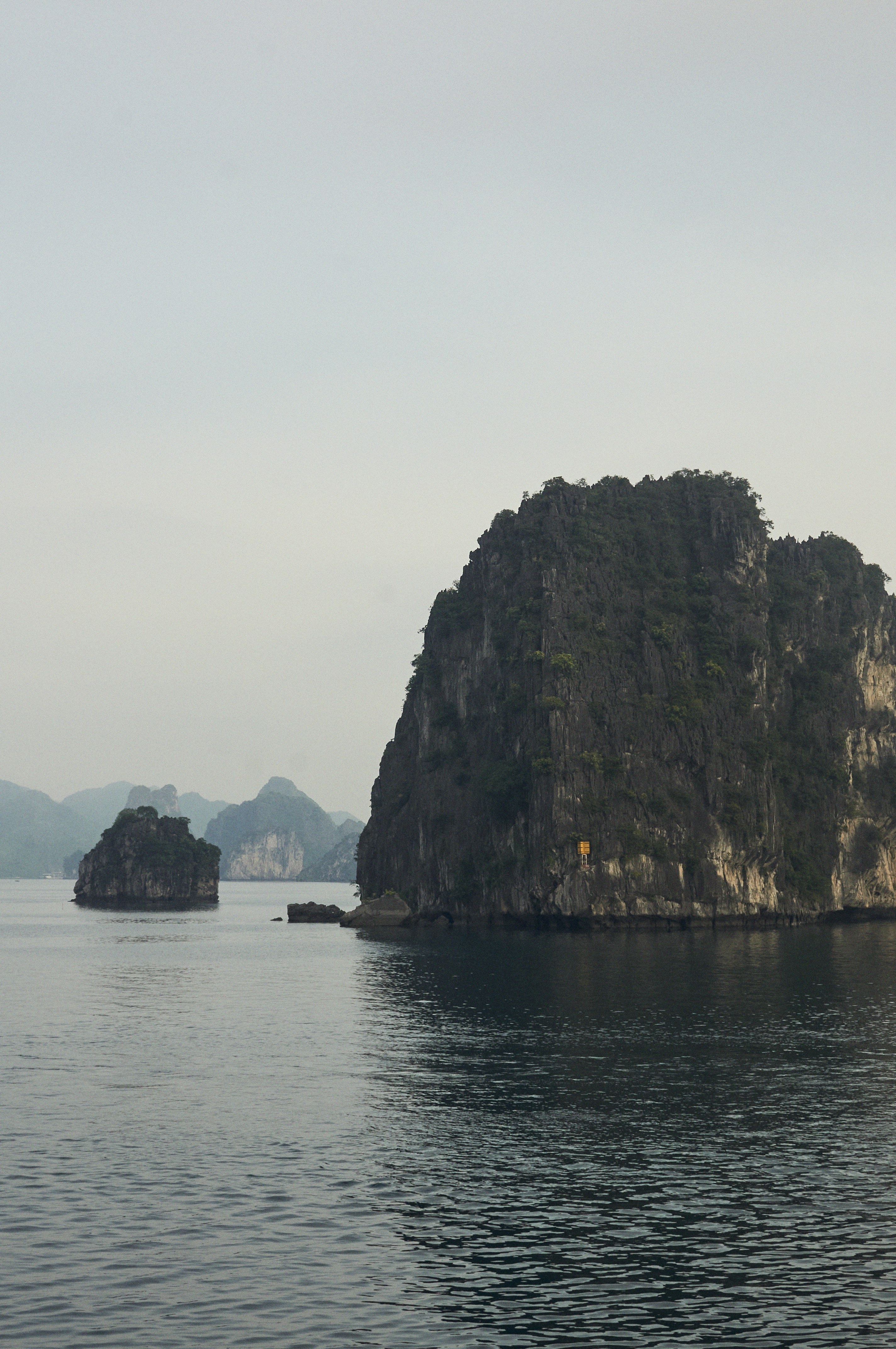 A group of rocks in the middle of a body of water