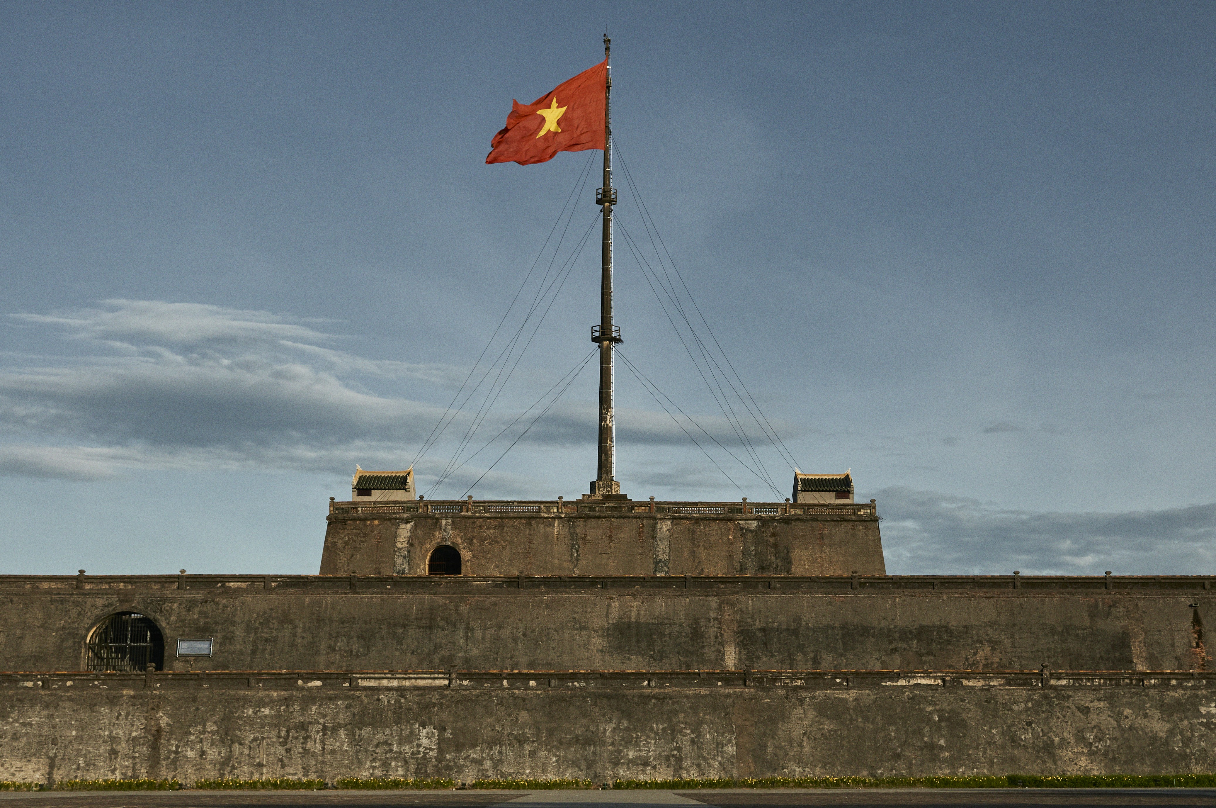 A red and yellow flag on top of a building