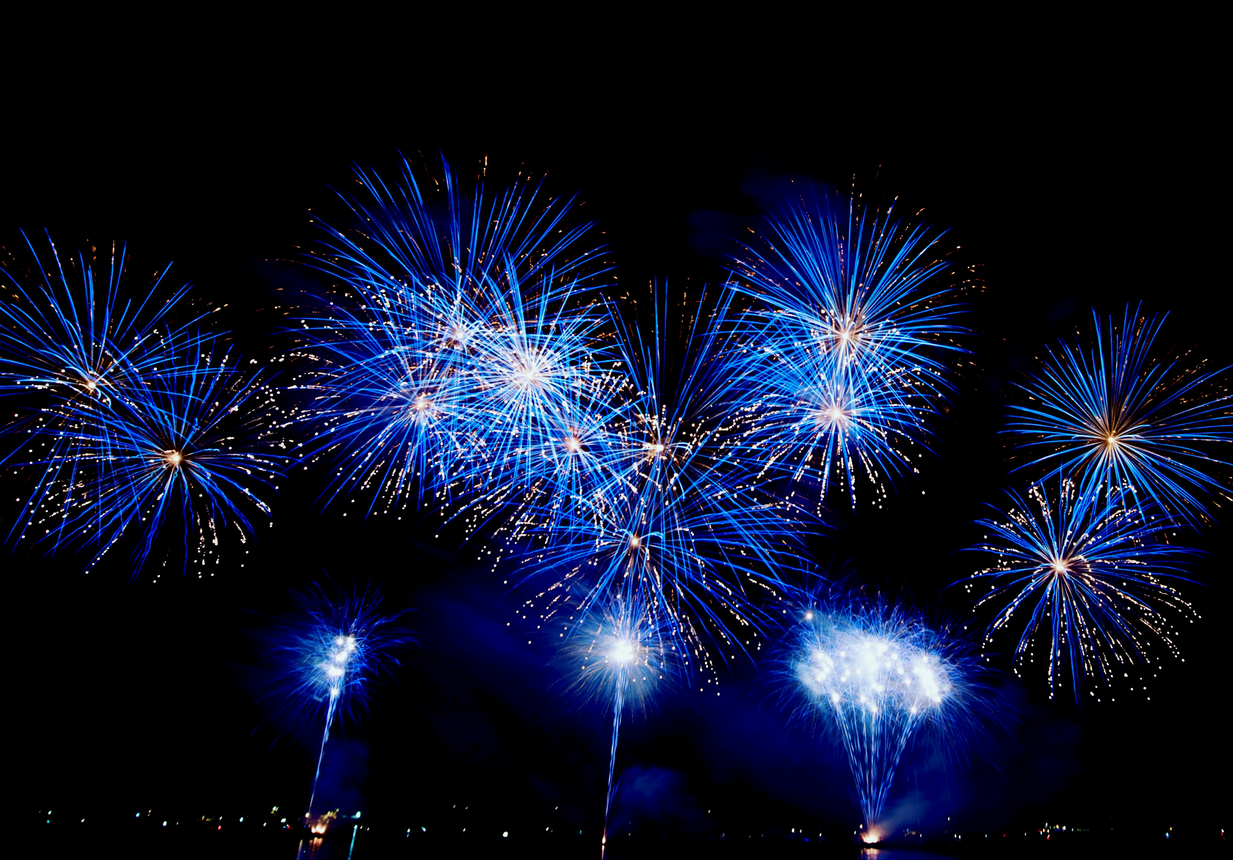A bunch of fireworks are lit up in the night sky