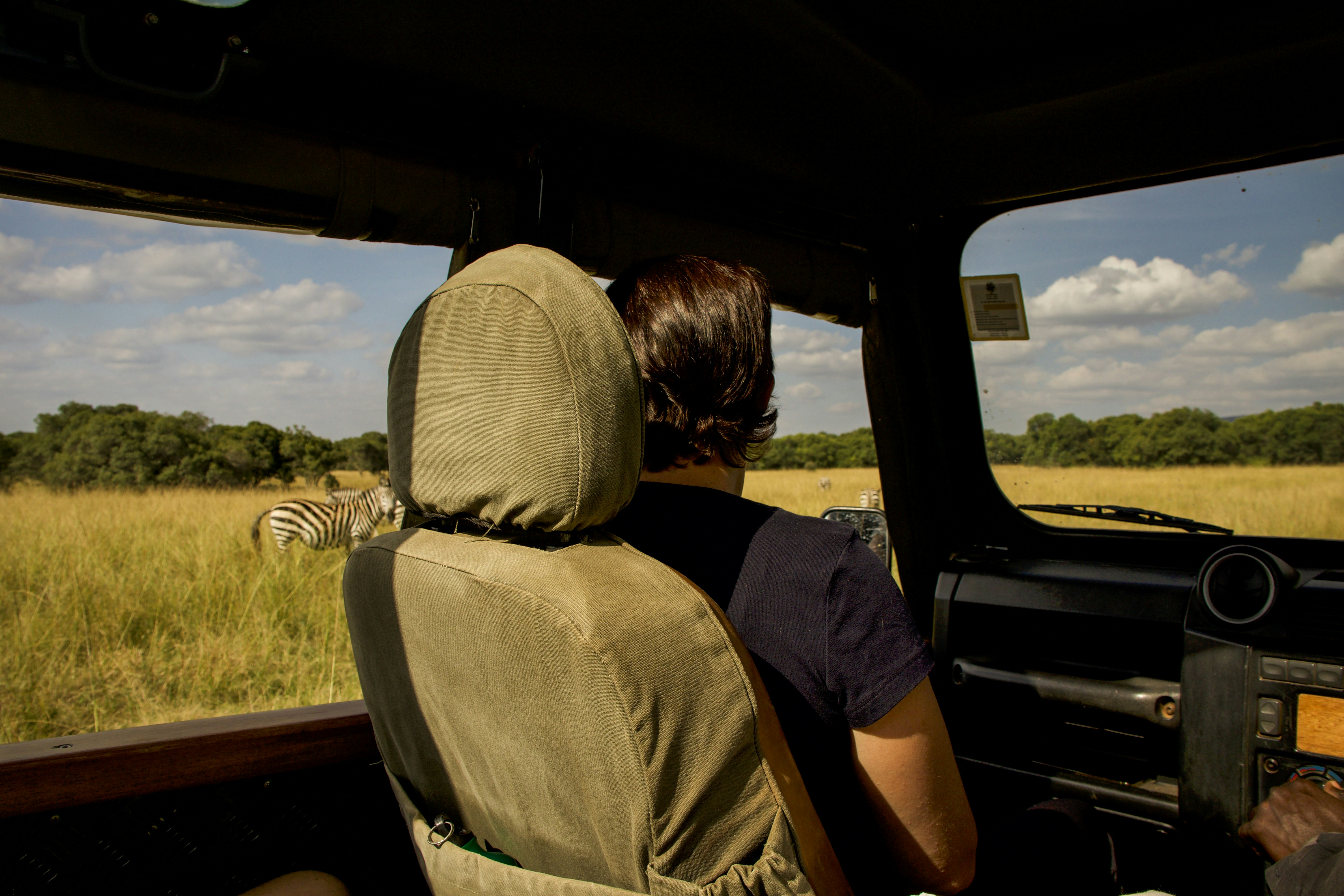 A person sitting in the back seat of a vehicle