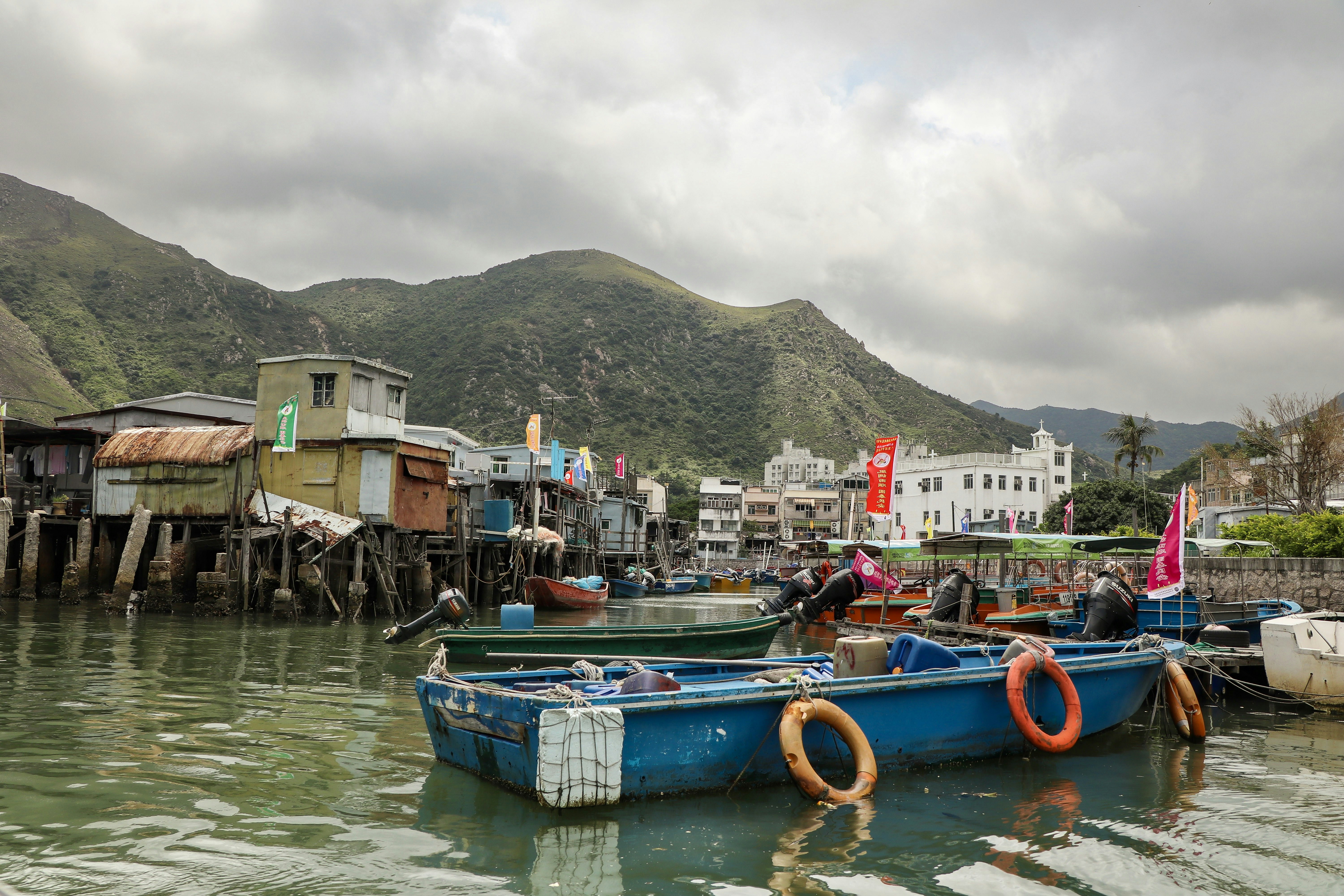 A blue boat floating on top of a body of water