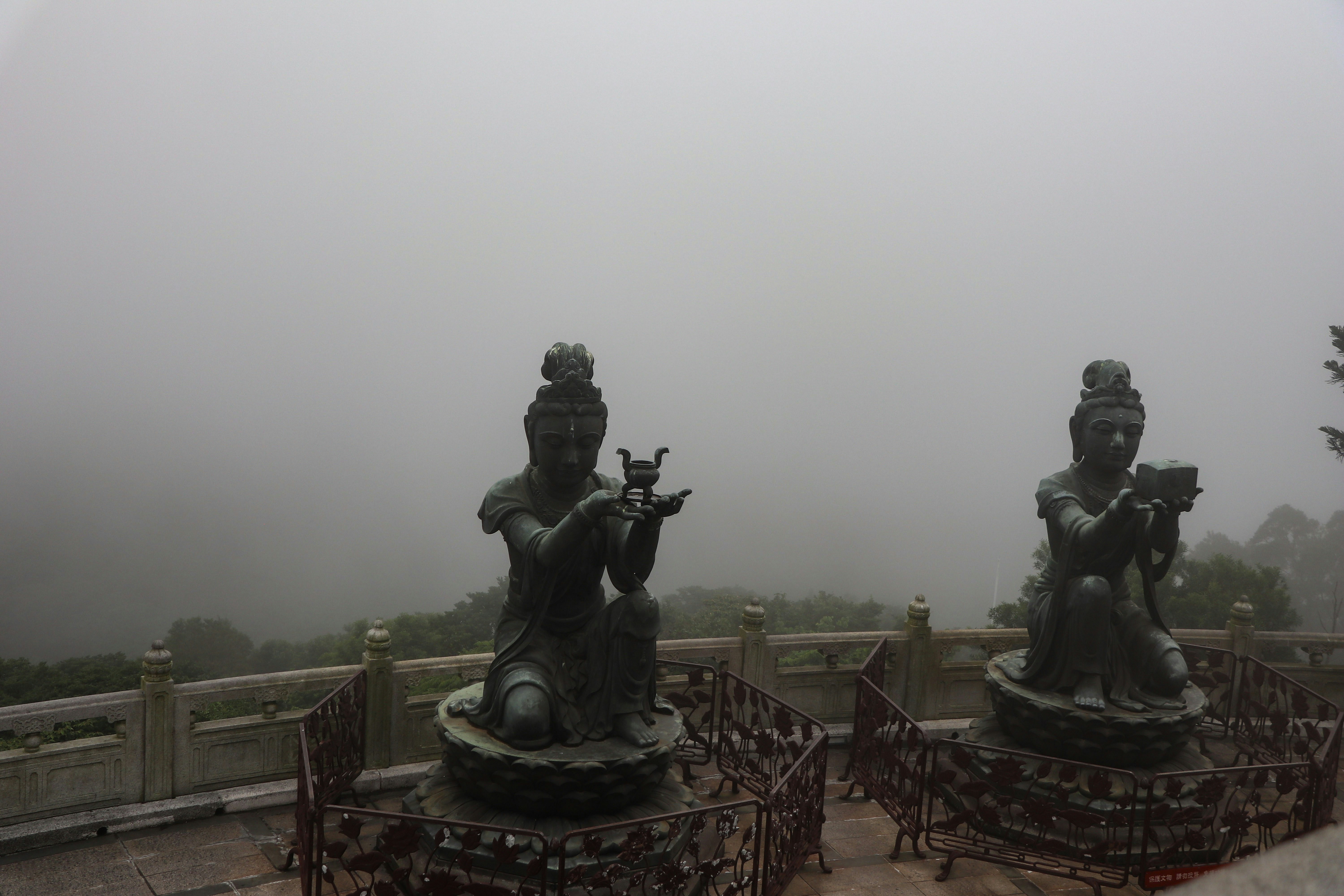 A group of statues sitting on top of a roof