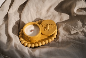 A couple of yellow rings sitting on top of a white sheet