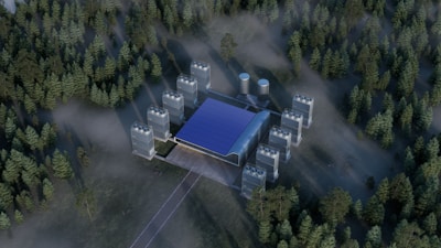 An aerial view of a building in the middle of a forest
