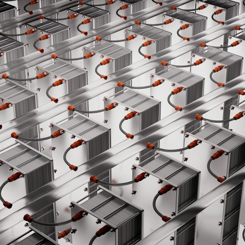 A close-up of lithium-ion battery cells arranged on a lab workbench