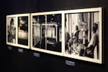 A group of black and white photographs hanging on a wall