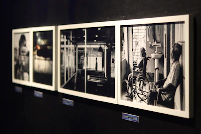 A group of black and white photographs hanging on a wall