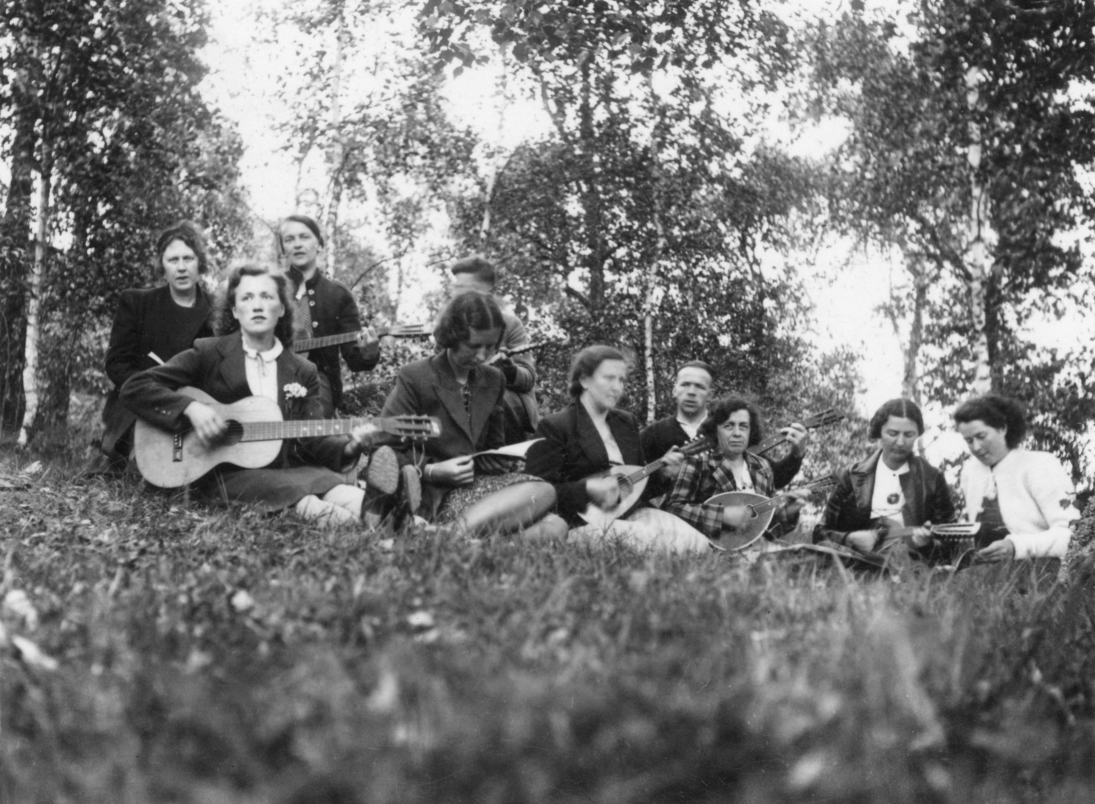 Group of people playing musical instruments outdoors