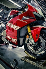 A red motorcycle is parked in a garage