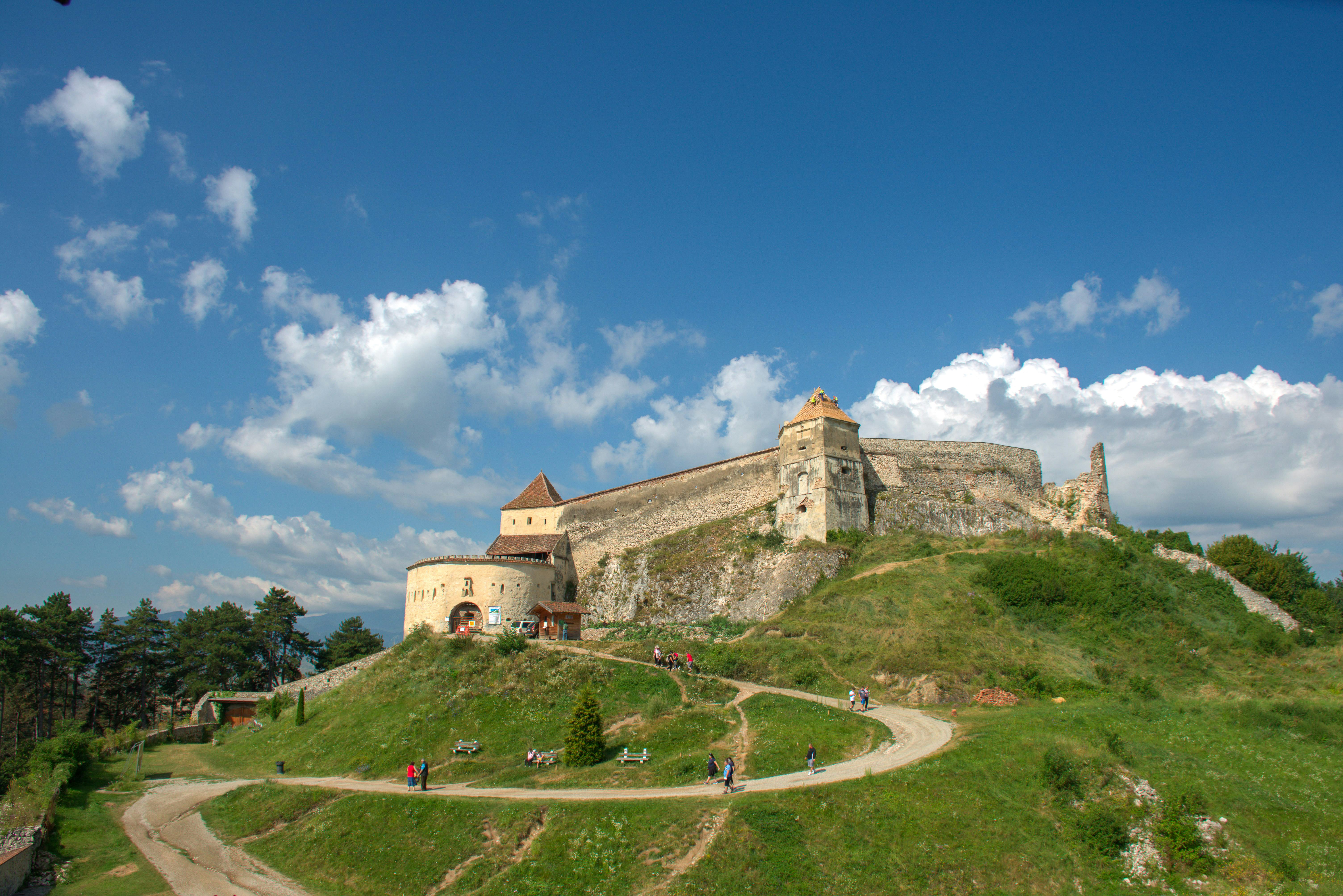 A large castle on top of a green hill