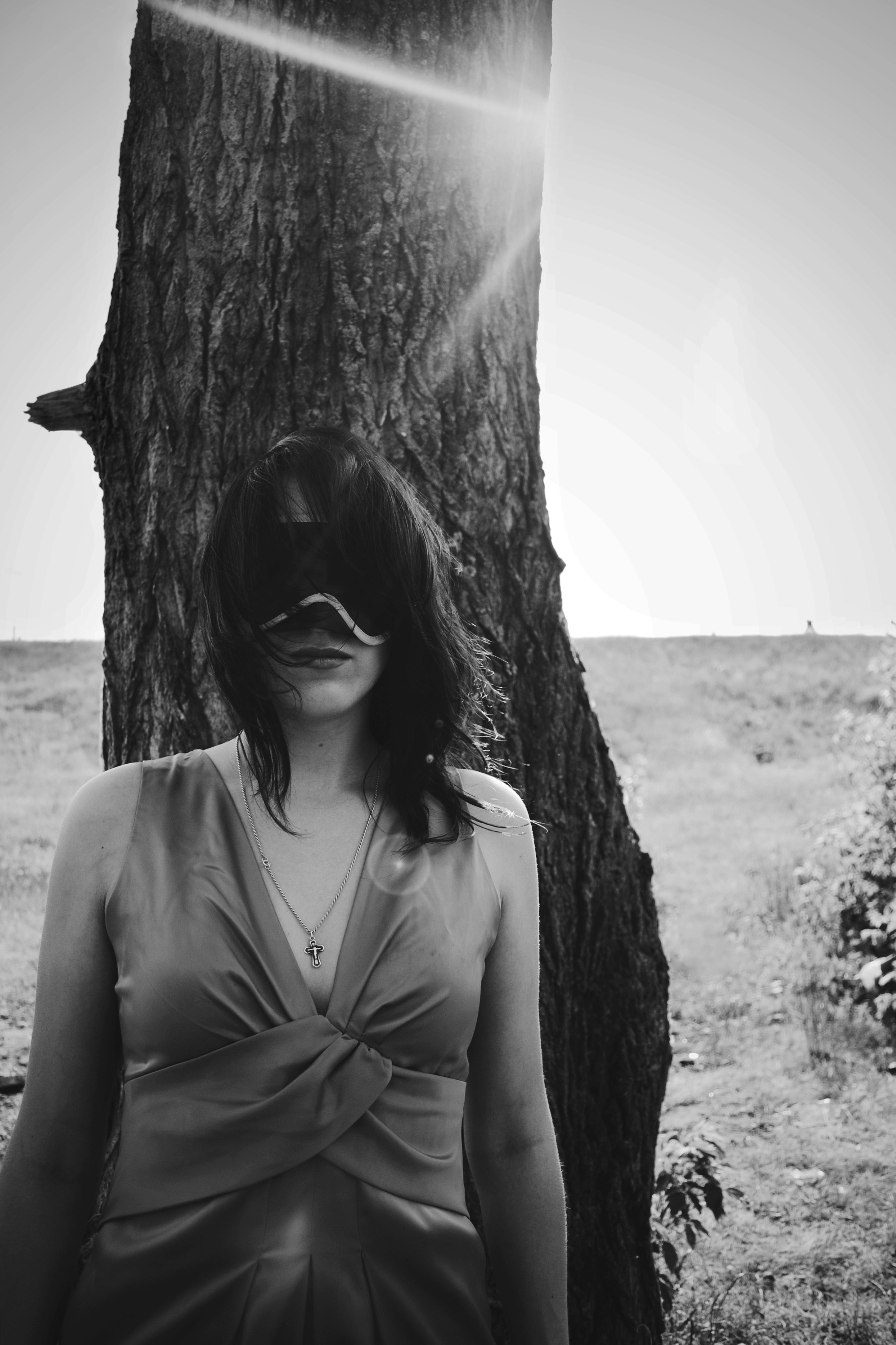 A woman standing in front of a tree