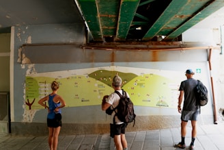 A group of people standing in front of a map