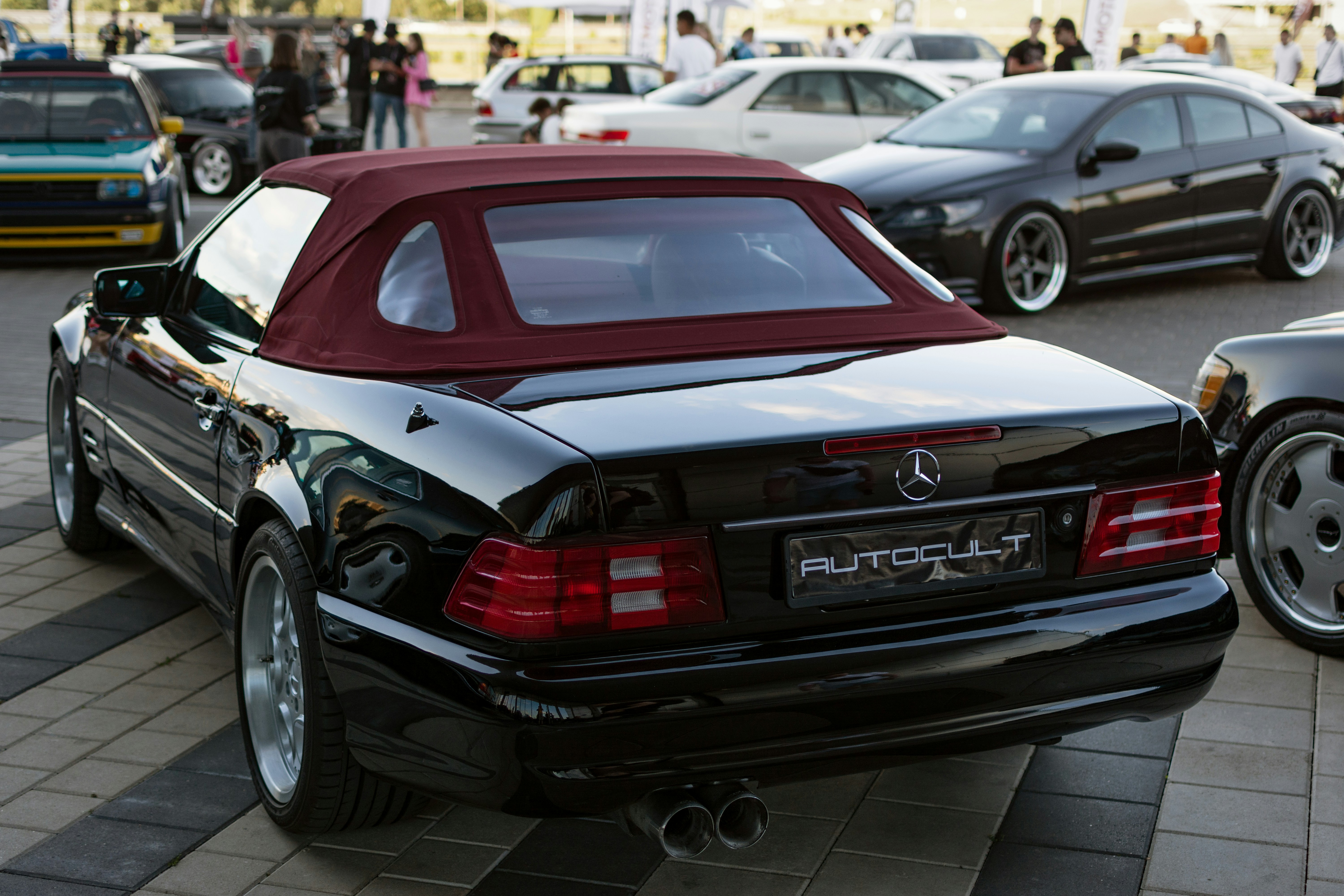 A group of cars parked next to each other in a parking lot
