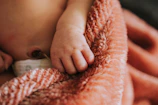 A close up of a baby wrapped in a blanket
