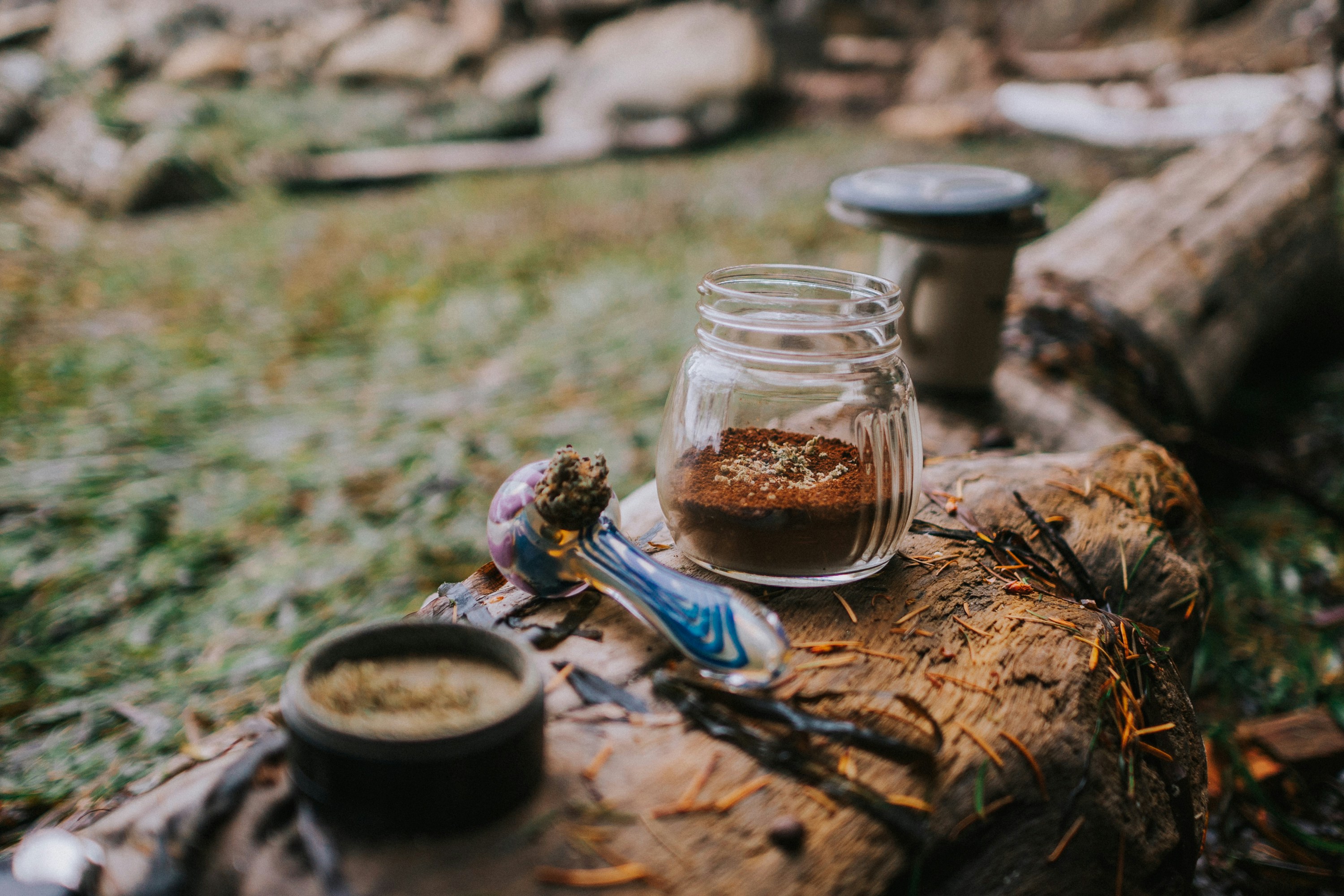 A couple of jars sitting on top of a log