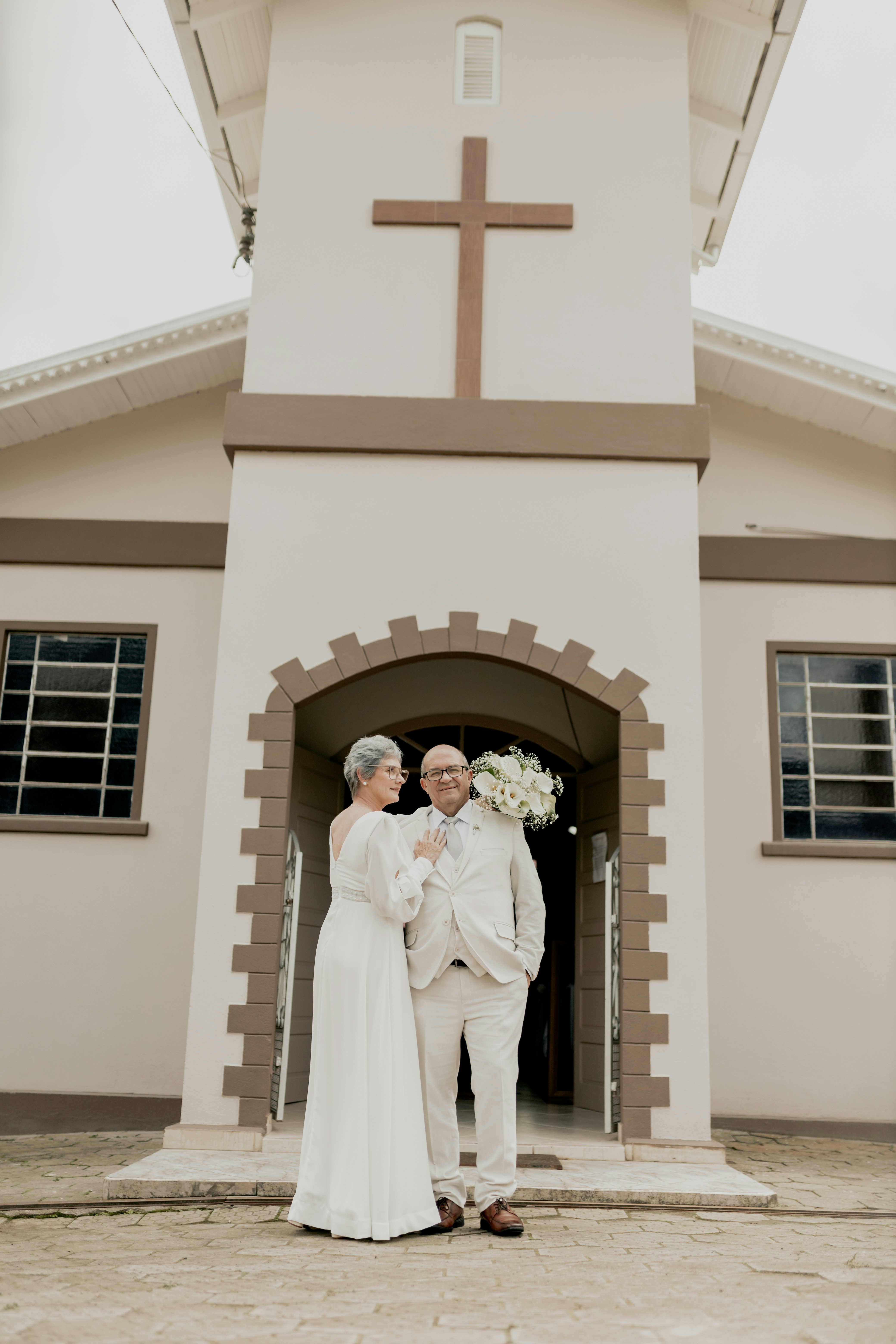 A man and woman standing in front of a church photo – Free Flower Image ...