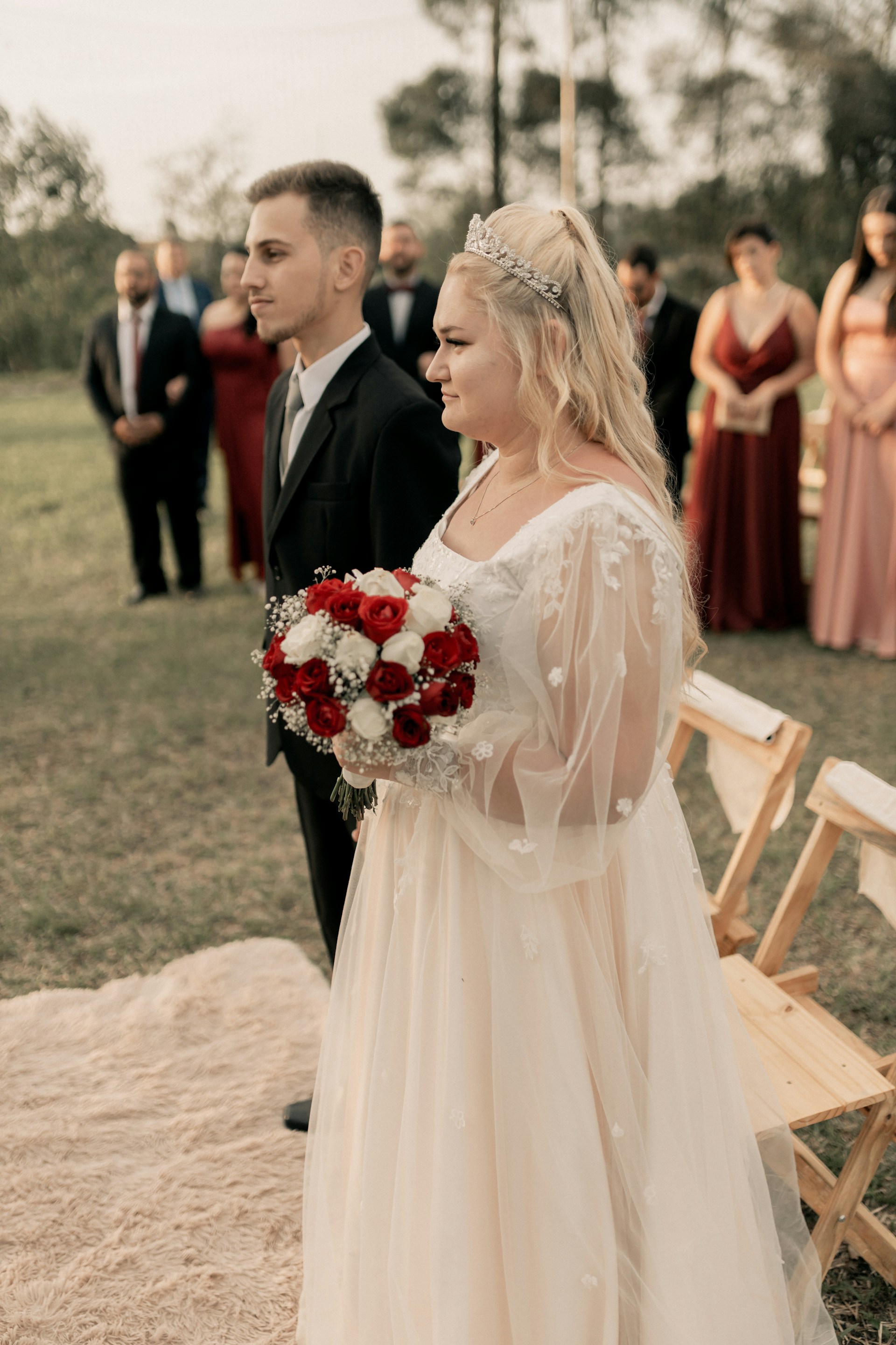 A woman in a wedding dress standing next to a man in a suit