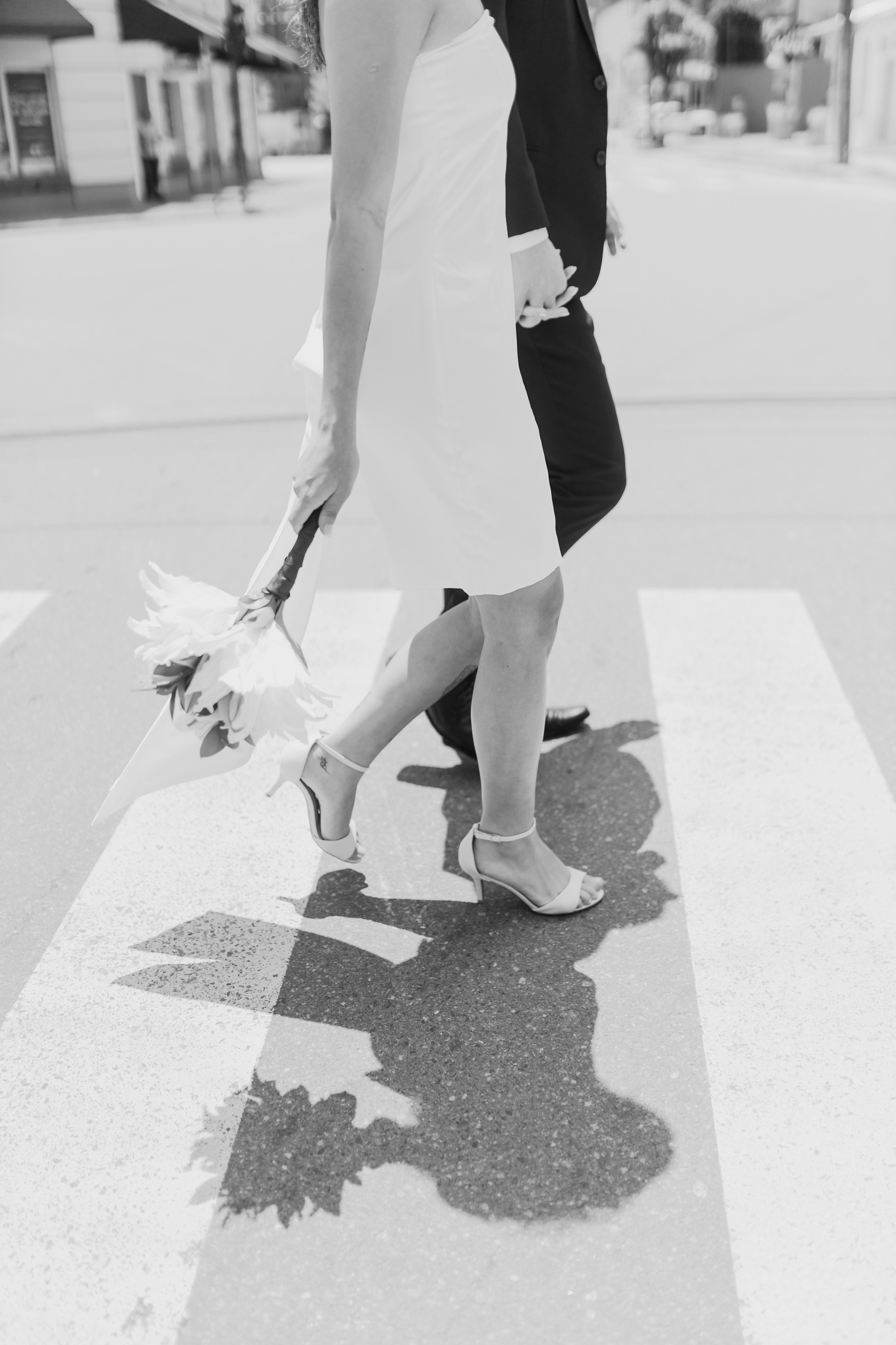 A couple of people that are walking down a street