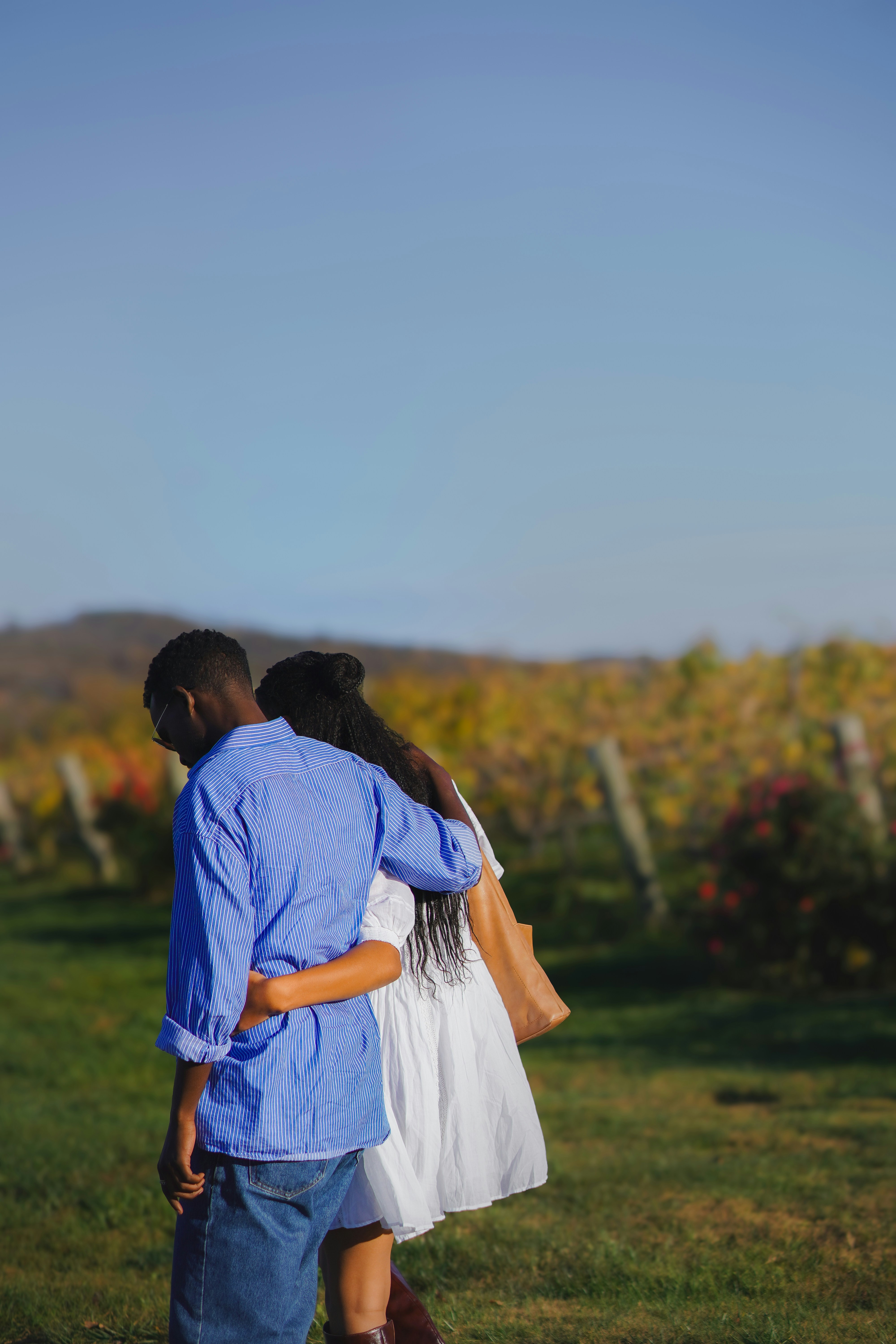 A man and a woman standing in a field