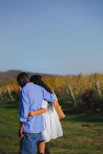 A man and a woman standing in a field