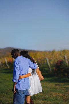 A man and a woman standing in a field