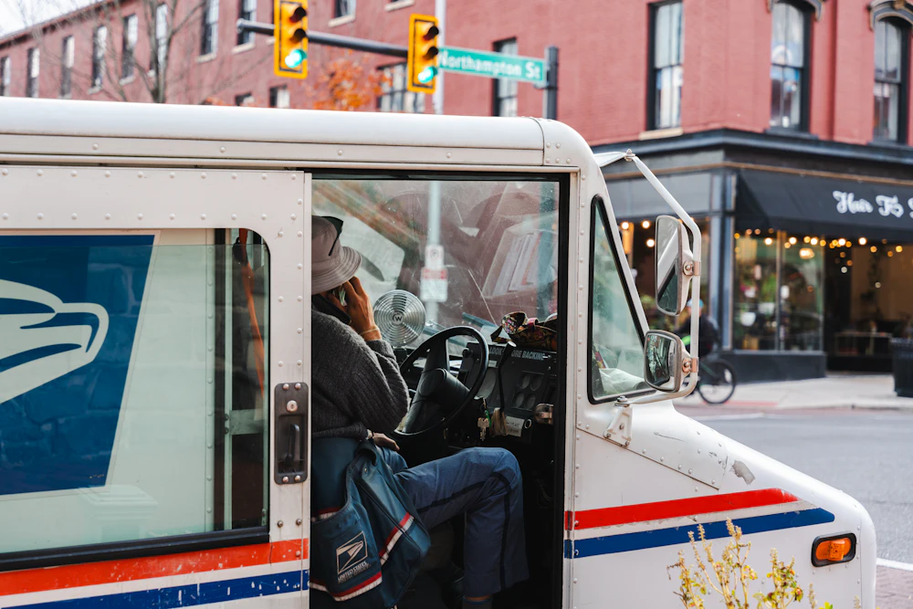 Mail truck driving down a city street