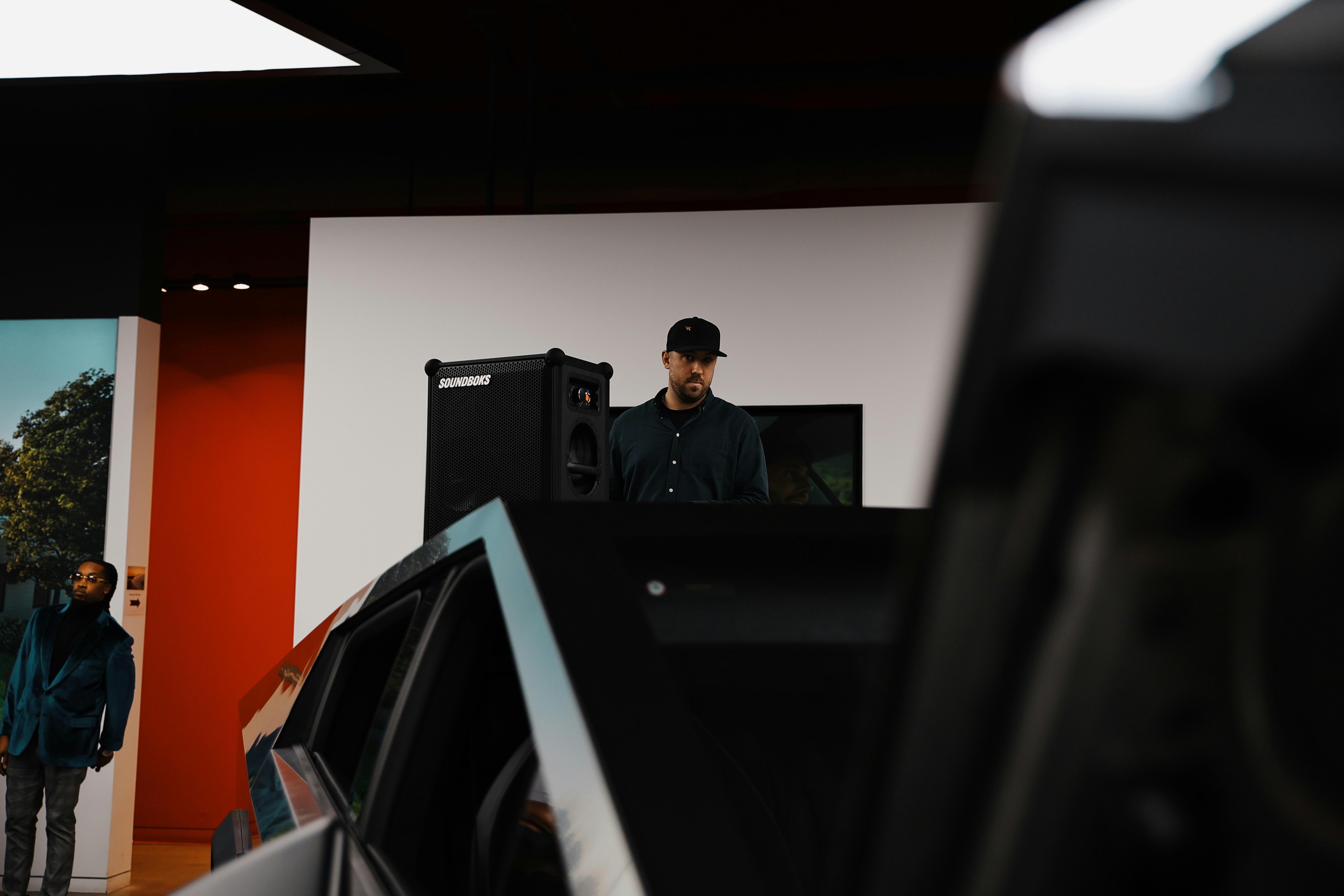 A group of people standing around a car