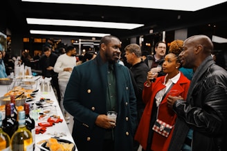 A group of people standing around a table