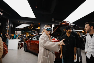 A group of people standing around a car showroom
