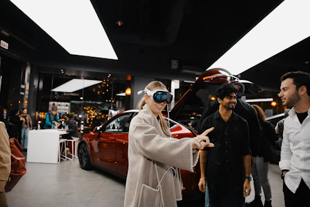 A group of people standing around a car showroom