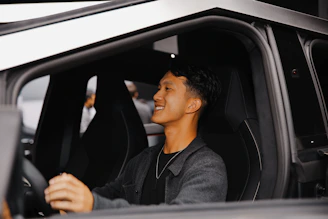 A man sitting in the driver's seat of a car