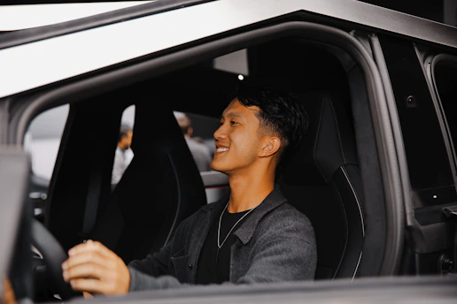 A man sitting in the driver's seat of a car