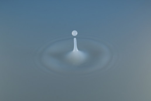 A picture of a drop of water on a blue background
